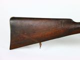 an old wooden rifle on a white surface with a white background