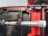 underside view of a red toy car with wheels and a steering