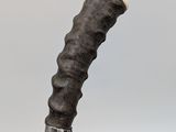 a knife that is sitting on top of a piece of wood