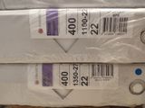 two packages of toilet paper are stacked on top of each other