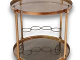 an antique brass bar cart with glass shelves and wheels
