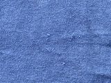 a close up of a piece of blue fabric with holes in it