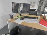 a desk with two monitors and a keyboard on it