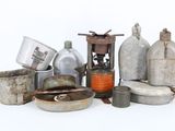 a lot of old metal pots and pans on the table