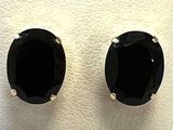 pair of black stone stud earrings sitting on top of a white surface