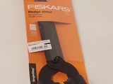 a pair of scissors sitting on top of an orange package