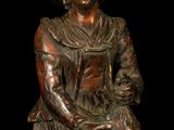 bronze statue of a woman holding a basket of flowers