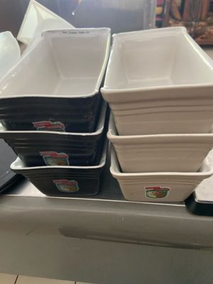 many trays of food sitting on a counter