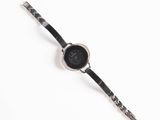 an image of a black and white watch on a white surface
