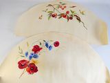 two pieces of cloth with flowers painted on them