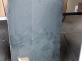 many boxes and boxes in a room with a refrigerator