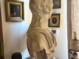 a bust of a man sitting on a table in a room