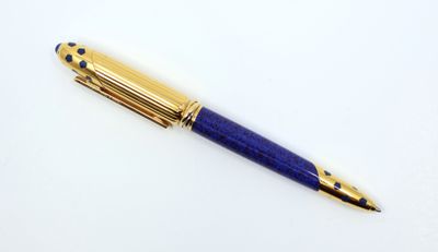 a close up of a pen on a white surface with a white background