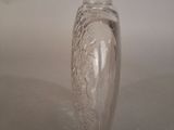 a clear glass vase sitting on top of a white table
