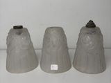 three gray vases sitting on top of a white shelf next to each other