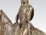 bronze statue of a man on a horse with a shield on his head