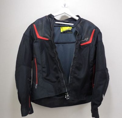 a close up of a jacket hanging on a hanger on a wall