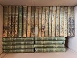 many old books in a box on the shelf