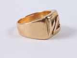 a close up of a gold ring on a white surface