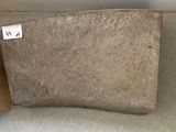 a piece of stone sitting on a shelf next to a wooden box