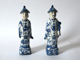 pair of blue and white figurines of a man and a woman