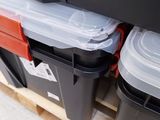 a stack of plastic containers sitting on a pallet