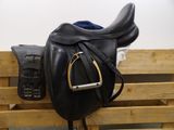 a black saddle and a black saddle on a wooden pallet
