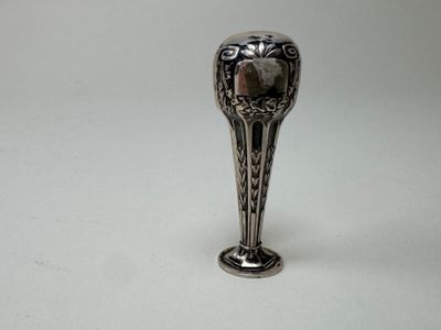 a silver spoon sitting on top of a white table