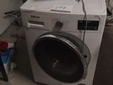 a washer and a dryer in a dirty room