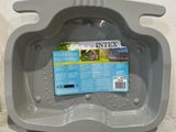 a gray litter can with a blue label on it