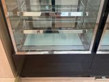 a glass display case in the middle of the floor