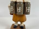 a figurine of a woman holding three cans