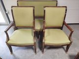 three chairs with green upholstered cushions and gold trim