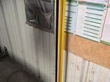 a yellow pole in the corner of a room