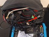 a bag of wires and a remote control on a table