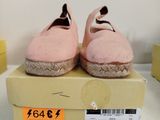a pair of pink shoes sitting on top of a box
