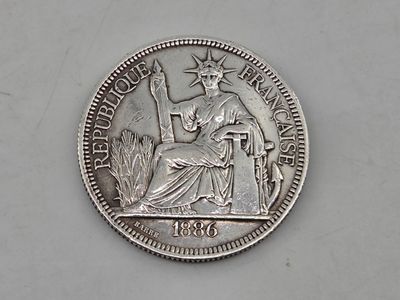 a close up of a silver coin with a statue of liberty on it