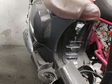 a motor scooter with a bag on the back of it