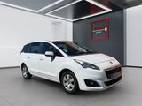 the small white car is parked in a large room