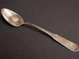 a spoon that is sitting on a black surface