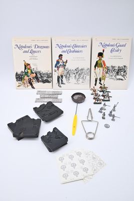 three books and a pair of scissors sitting on a table