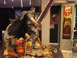 statue of a man with a sword on a table in a room