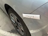 a sticker on the side of a silver car