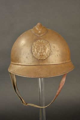 an old helmet with a lion head on the side of it