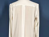an image of a white shirt on a mannequin stand