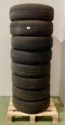 a stack of tires sitting on a pallet on the floor