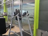 a view of a gym room with equipment in it