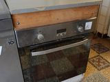 a stove and oven in a kitchen with a tiled floor