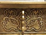 a close up of a metal box with a design on it
