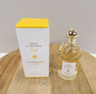 a bottle of perfume sitting on top of a wooden table